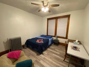 a bedroom with a bed and a couch and a ceiling fan at Short Term Rentals Little Italy Cleveland in Cleveland +20 photos