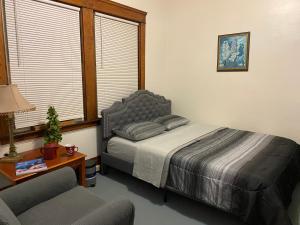 a bedroom with a bed and a table and a chair at Short Term Rentals Little Italy Cleveland in Cleveland