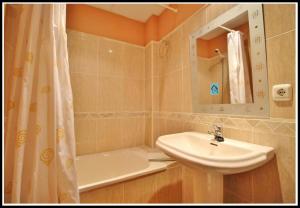 a bathroom with a sink and a toilet and a tub at Villas Cañada in Torrox Costa