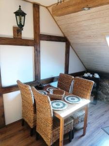 a dining room with a table and chairs at Janowa Góra Apartament in Stronie Śląskie