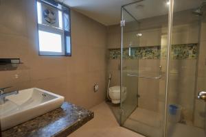 a bathroom with a shower and a sink and a toilet at Eternal wave by HappyInch in Calangute