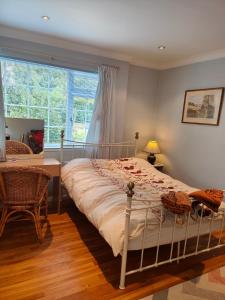 a bedroom with a bed and a table and a window at Bracken Lodge in Merston