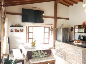 a living room with a fireplace and a tv on the wall at Beautiful Lake View Villa. Lake Access & Near Town in Guatapé