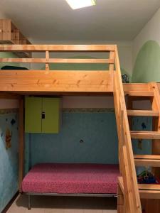 a bunk bed in a childs bedroom with a bunk bed under a ladder at Casa Vale fronte mare in Ventimiglia
