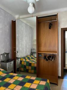 a bedroom with two beds and a sliding door at Casa Vale fronte mare in Ventimiglia