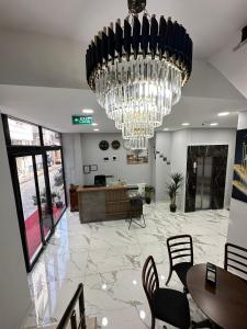 a lobby with a large chandelier and tables and chairs at Marista Pansiyon in Istanbul