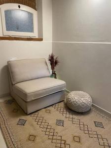a chair sitting in a room with a rug at BellaFlo: Small apartment in the center of Florence in Florence