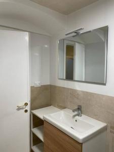 a bathroom with a sink and a mirror at BellaFlo: Small apartment in the center of Florence in Florence