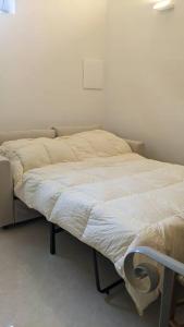 a small bed in a room with at BellaFlo: Small apartment in the center of Florence in Florence