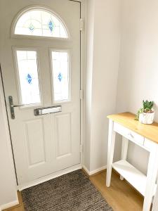 a white door with a window and a table at Townhouse in Derby in Derby