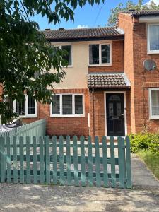 una valla verde frente a una casa de ladrillo en Townhouse in Derby en Derby