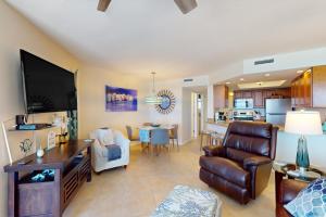 a living room with a couch and a dining room at By The Sea Turtles in Ponce Inlet