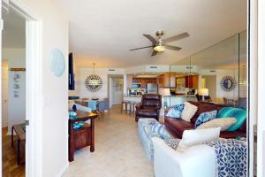 a living room with a couch and a ceiling fan at By The Sea Turtles in Ponce Inlet