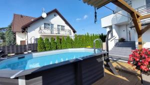 a swimming pool in the backyard of a house at GoldenApart Willa -Apartamenty z dwoma sypialniami, basen in Krynica Morska