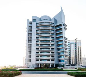 a large white building with a lot of windows at Pyramisa Hotel Apartments in Dubai