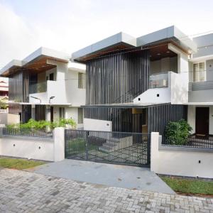 a building with a fence in front of it at Zennova Furnished Apartment in Alleppey