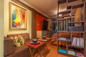 a living room with a couch and a table at Choose To Be Happy at Seymour # 9 and #16 - Studio Apartments in Kingston