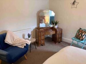 a bedroom with a desk with a mirror and a chair at Inviting 3-Bed House in Sunderland WiFi Parking in Sunderland