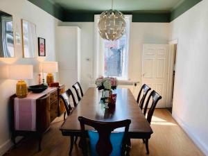 a dining room with a table with chairs and a chandelier at Inviting 3-Bed House in Sunderland WiFi Parking in Sunderland