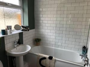 a bathroom with a sink and a bath tub and a sink at Rose Cottage - 5 Person city centre with parking in Sunderland +20 photos