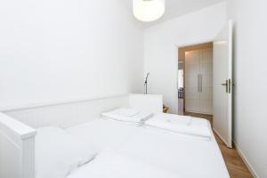 a white bedroom with a white bed and a hallway at BELVEDERE - Garda Leisure in Salò