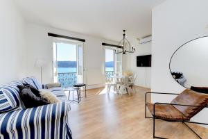 a living room with a couch and a table at BELVEDERE - Garda Leisure in Salò