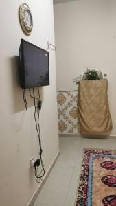 a living room with a flat screen tv on the wall at An appartment for rent in Ajman Alreqah Building in Ajman 