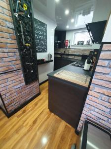 a kitchen with a counter and a brick wall at Little House On The Hill Conisbrough in Conisbrough