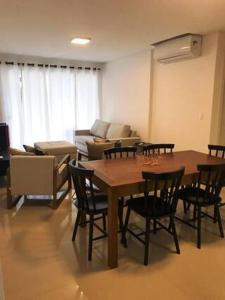 a living room with a table and chairs and a couch at Summer Paradise - 3 Quartos in Governador Celso Ramos