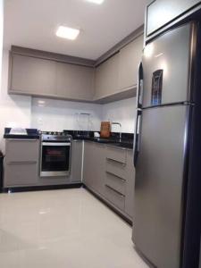 a kitchen with a stainless steel refrigerator at Summer Paradise - 3 Quartos in Governador Celso Ramos