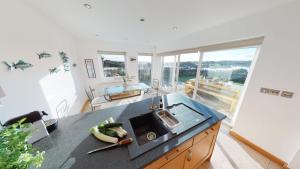 a kitchen with a sink and a counter with bananas on it at House on the Beach in Valley