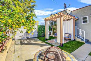 a backyard with a gazebo and an orange tree at Modern 2-Bedroom Haven in the Heart of LA- HUD-VP in Los Angeles