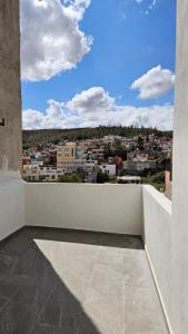 a balcony with a view of a city at Casa Mexicapan Centro Zacatecas in Zacatecas
