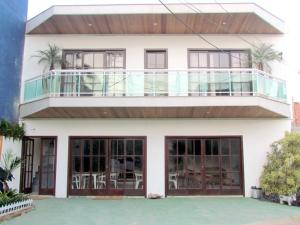 a house with a balcony on top of it at Pousada Belafonte Riocentro in Rio de Janeiro