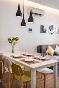 a dining room with a white table and chairs at Republic Apartments Saigon Airport in Ho Chi Minh City