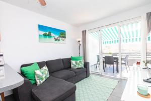 a living room with a couch and a table at Hilltop Vista Apartment in Puerto Rico de Gran Canaria