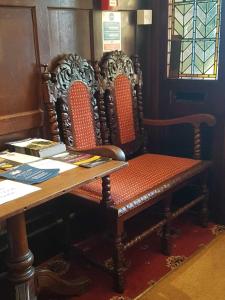 a desk with two chairs and a table with a bench at The Lismore Hotel in Banbury
