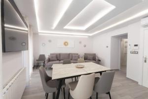 a white living room with a table and chairs at VTAR Puerta Del Sol in Villacarrillo