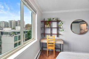 a bedroom with a desk and a window with a mirror at Private Penthouse in the heart of Seattle with views in Seattle