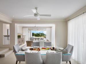 a dining room with a table and chairs at Apes Hill Barbados Golf and Resort Community in Saint James