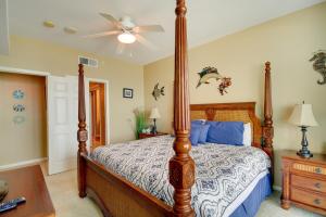 a bedroom with a bed and a ceiling fan at Beachfront Gulfport Vacation Rental with Balcony! in Gulfport