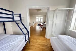 a room with two bunk beds and a dining room at Beautiful 2 bedroom apartment downtown Reykjavik in Reykjavík