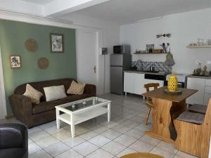 a living room with a couch and a table at Gîte du vieux moulin in Ravilloles