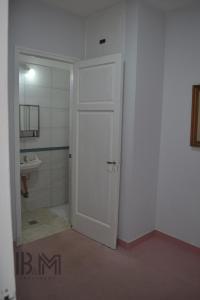 a bathroom with a white door and a shower at B&M in Mendoza