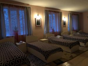three beds sitting in a room with windows at Guest house in Alaverdi in Alaverdi