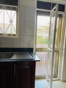 a kitchen with a window and a counter top at Khael Glory home offers 247 security in Kampala