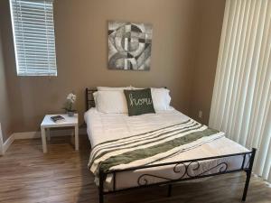 a bedroom with a bed and a table with a window at 2BR Condo 15 mins to Downtown Phoenix with Pool & Spa in Phoenix