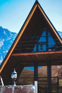 a building with a roof with a picnic table on it at Peak view kazbegi in Stepantsminda