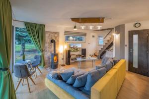 a living room with a couch and a living room with a fireplace at Vilka u Dyje in Znojmo