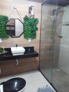 a bathroom with a toilet and a sink and a shower at Chalé Adventure in Serra de São Bento